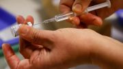 An injection is preparing to push a vaccine