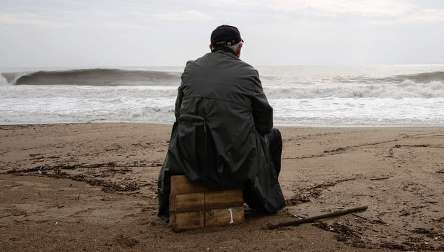 a man sitting alone in sea beach